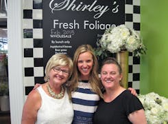 Trisha, Shelby and Jo share a happy moment during a fresh foliage sale